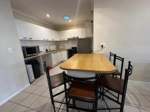 a small kitchen with a wooden table and chairs at Gorgeous Holiday Home in Monte Vista