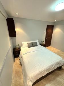 a bedroom with a large white bed in it at Evergreen Private Pool Villa - Cavite in General Trias