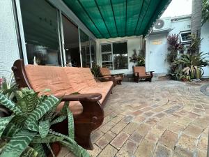 a couch on a patio with chairs and plants at Gorgeous Holiday Home in Monte Vista