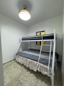 a bedroom with two bunk beds in a room at Brisa del Rio Jimenoa in Jarabacoa