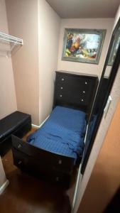 a bedroom with a bed and a painting on the wall at Cabin 4 The Roost Cabins in Lakehills +20 photos