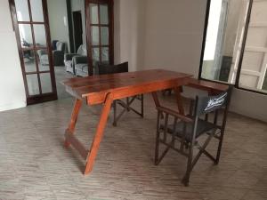 a wooden table and a chair in a room at SB hostel in La Rioja +4 photos