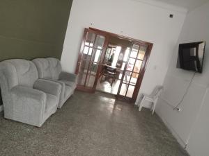 a living room with a couch and a television at SB hostel in La Rioja