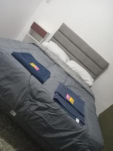 a bed with two blue towels on top of it at SB hostel in La Rioja