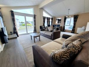 a living room with a couch and a table at Birchington Vale - Delta Lodge in Kent