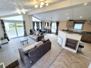 a living room with a couch and a fireplace at Birchington Vale - Delta Lodge in Kent
