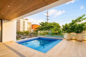 a swimming pool on the roof of a building at Comfy City Center 1BR Condo in Los Prados