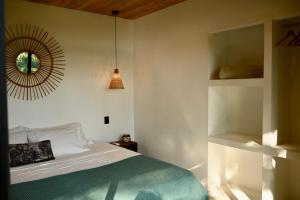 a bedroom with a bed and a mirror on the wall at Villa Wayra in Santa Teresa Beach