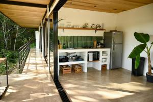 a kitchen with a sink and a refrigerator at Villa Wayra in Santa Teresa Beach +16 photos