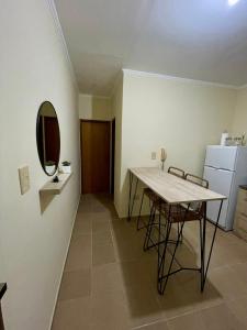 a dining room with a table and a mirror at Chill Home VIII in Posadas
