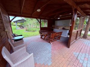 an outdoor patio with a table and a bench at U Marzeny in Malbork