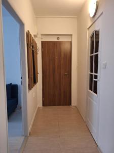 a hallway with a wooden door in a room at ApartmanONE in Hlohovec