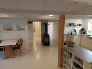 a kitchen with a stove in the middle of a room at Sønderhedens B&B in Vrå