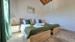 a bedroom with two beds with towels on them at Blue Lagoon Villa in Achada +36 photos