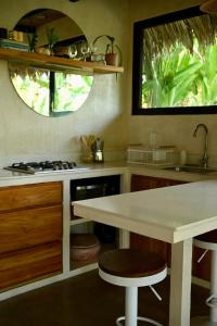 a kitchen with a counter and a sink and a counter stool at Villa Wayra in Santa Teresa Beach