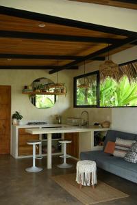 a kitchen and living room with a table and a couch at Villa Wayra in Santa Teresa Beach
