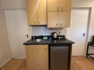 a kitchen with a sink and a counter top at Cute Pool Side Apartment in Monte Vista
