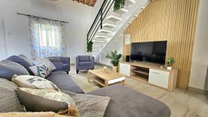 a living room with a couch and a flat screen tv at Blue Lagoon Villa in Achada