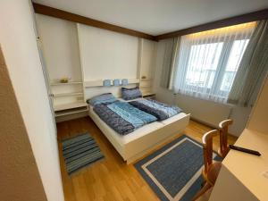 a small bedroom with a bed and a window at Landhotel Max & Moritz in Liebenau