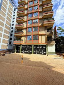a large apartment building with a lot of windows at One Bedroom Roysambu Mirema Drive in Nairobi