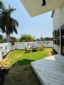 a backyard with a table and chairs and a fence at The Regalis Villa in Lucknow +22 photos