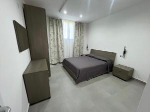 a bedroom with a bed and a window at Casa Vacanze Tortora in Tortora