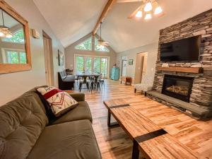 a living room with a couch and a fireplace at Lakefront Dock Fire Pit Hot Tub Value in Swanton