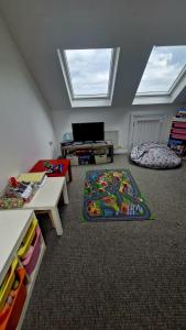 a attic room with two skylights and a living room with two tables at Ocean Heights House in Dunfanaghy