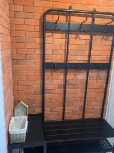 a bike rack against a brick wall with a basket at Siódme niebo in Gdańsk
