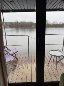 a porch with a table and a chair on a boat at Water House in Puck