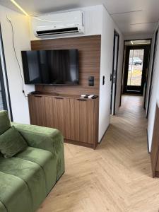 a living room with a couch and a flat screen tv at Water House in Puck