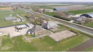 an aerial view of a house with a yard at vredehof appartement in Sint Maartensbrug