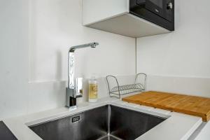 a kitchen with a sink and a counter top at The Blue House - Mediterranean Loft in Faro +40 photos