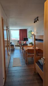 a living room with a couch and a living room with a table at Himmelsleiter in Sankt Englmar +41 photos