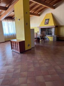 a large room with a table and a fireplace at Foresto Case Vacanza in Volta Mantovana
