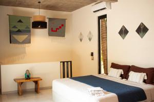 a bedroom with a bed and a table and a window at Casa Sol Sombra in Brisas de Zicatela +62 photos