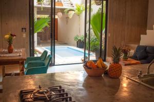 a kitchen with a stove and a swimming pool at Casa Sol Sombra in Brisas de Zicatela