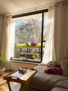 a living room with a couch and a window at Cozy flat near park in Netanya