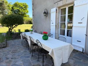 a white table and chairs on a patio at Chez Paulet A welcome break for peace and tranquility - route C27 in Lobard