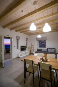 a dining room and living room with a table and chairs at Mystic Harmony in Mikonos