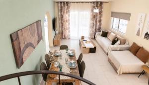 a living room with a table and a couch at Villa Aelia Luxury Maisonette in Salamina