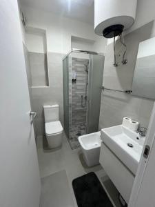 a white bathroom with a toilet and a sink at Casa Vacanze Tortora in Tortora +20 photos