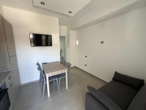 a small living room with a table and a couch at Casa Vacanze Tortora in Tortora