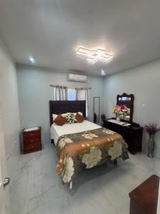 a bedroom with a large bed and a mirror at Faith moves mountains in Ocho Rios