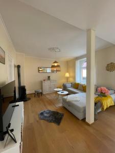 a living room with a couch and a table at Le Cocon Turckheim in Turckheim