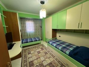 a room with two beds and a desk in it at SunBeach Apartament in Golem