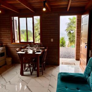 a dining room with a table with wine glasses on it at Villetta Gramado Roma in Gramado +29 photos
