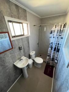 a bathroom with a sink and a toilet and a window at Hostal JVDepartamento B in Nogales
