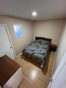 a bedroom with a bed in the corner of a room at Hostal JVDepartamento B in Nogales