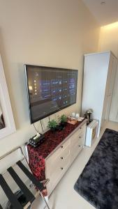 a living room with a large television on a dresser at دار طيبة in Medina